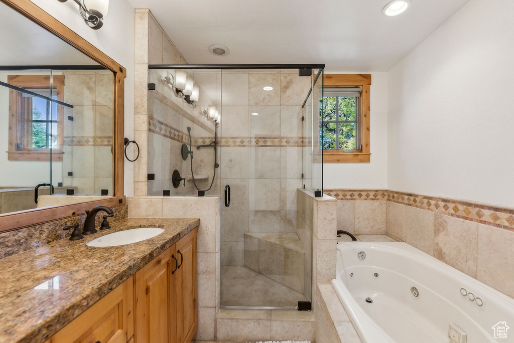 Bathroom with vanity and separate shower and tub