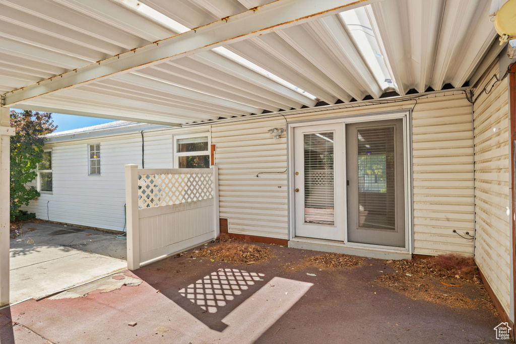 Doorway to property featuring a patio area