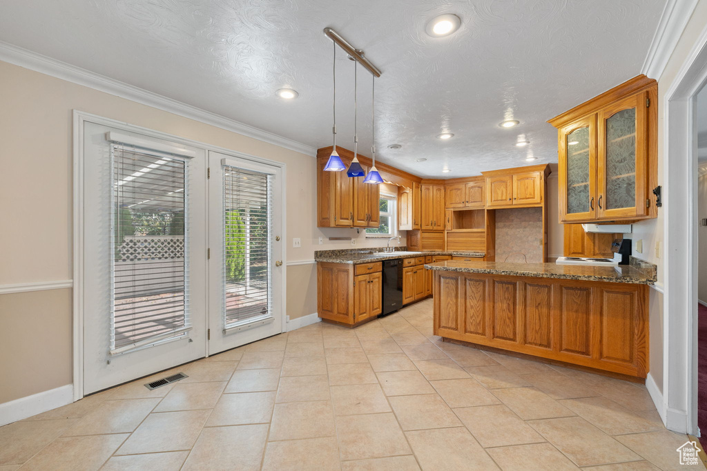 Kitchen featuring light stone countertops, sink, a textured ceiling, decorative light fixtures, and crown molding