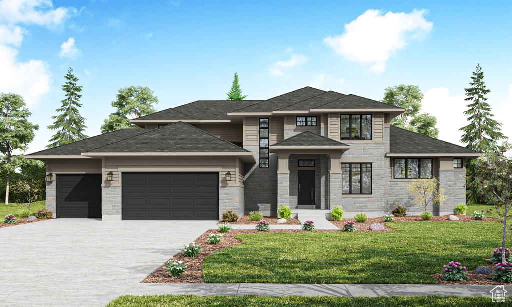 Prairie-style home featuring a front yard and a garage