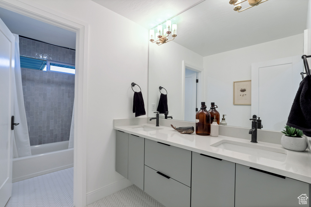 Bathroom with vanity, shower / tub combo, and tile patterned flooring