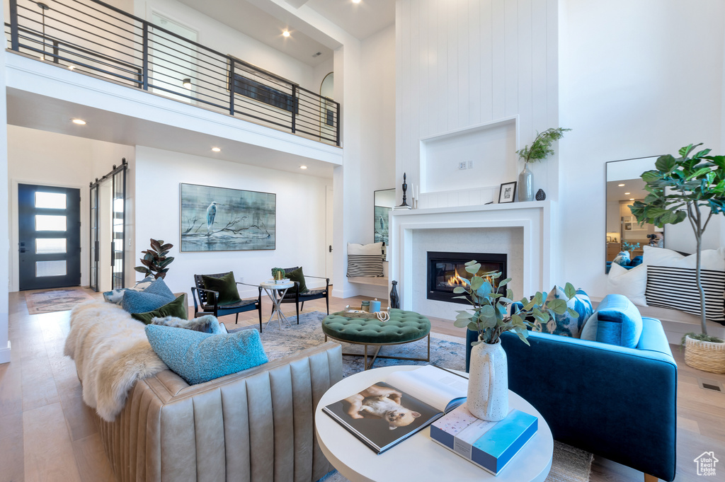 Living room featuring light hardwood / wood-style floors and a high ceiling