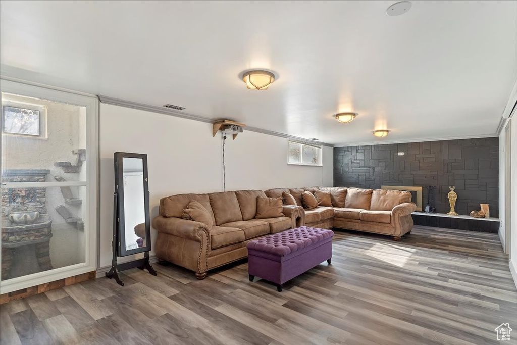 Living room featuring ornamental molding and wood-type flooring