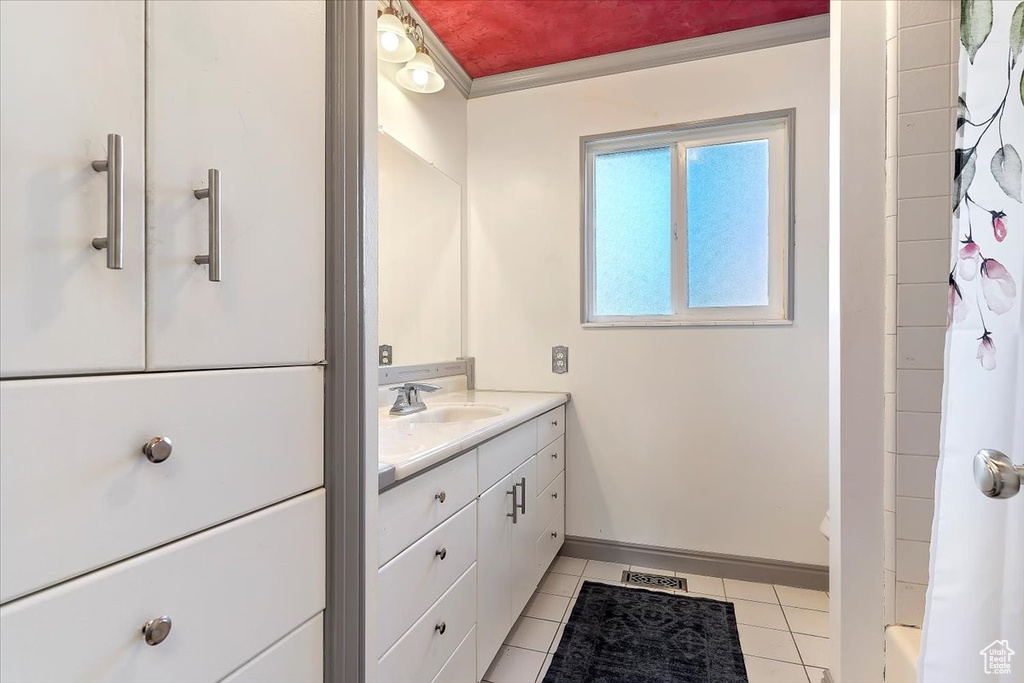 Bathroom with curtained shower, toilet, tile patterned floors, vanity, and crown molding