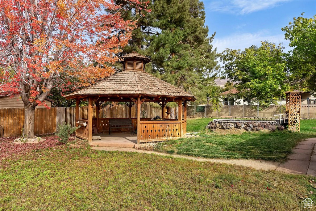 View of community featuring a gazebo, a patio area, and a yard