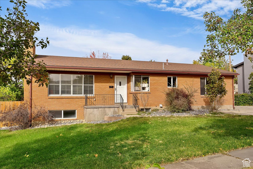 Single story home featuring a front yard