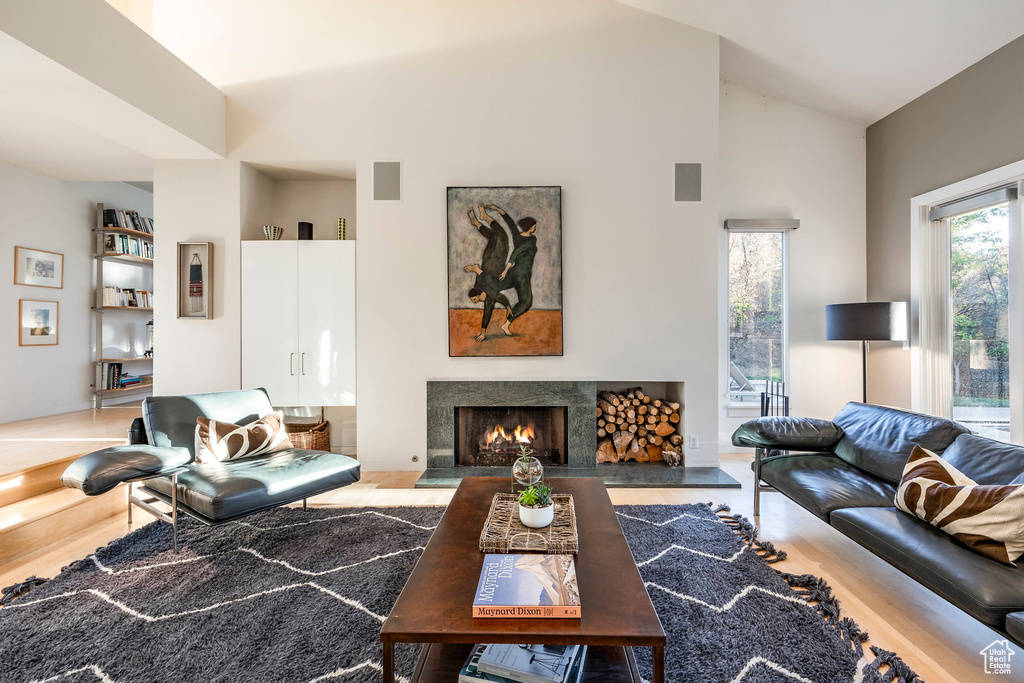 Living room featuring hardwood / wood-style flooring and vaulted ceiling