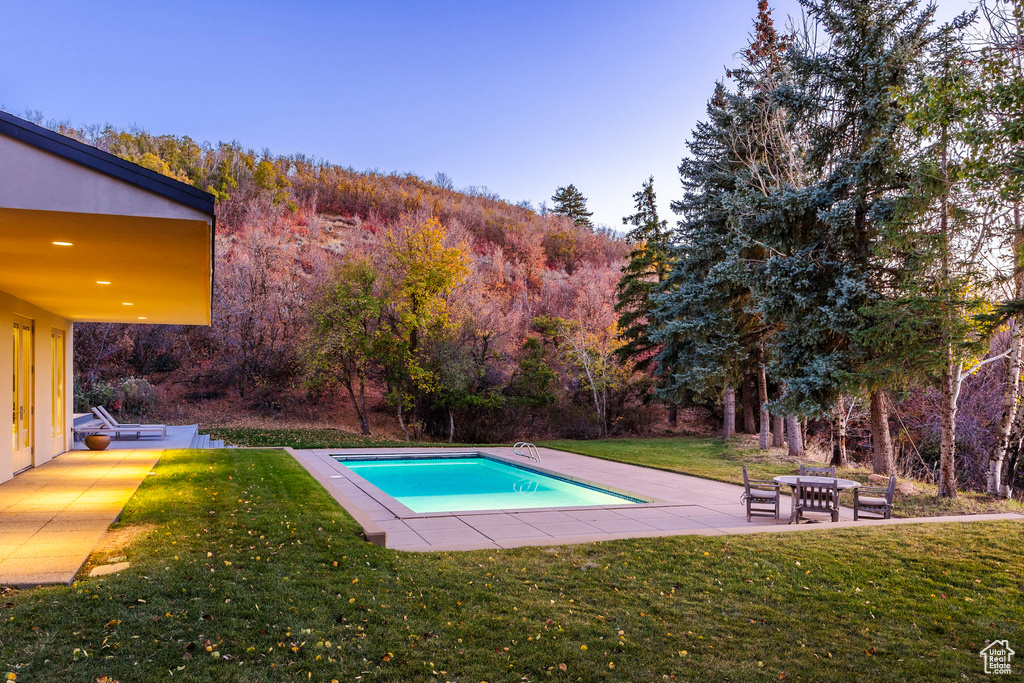 View of swimming pool featuring a yard and a patio area