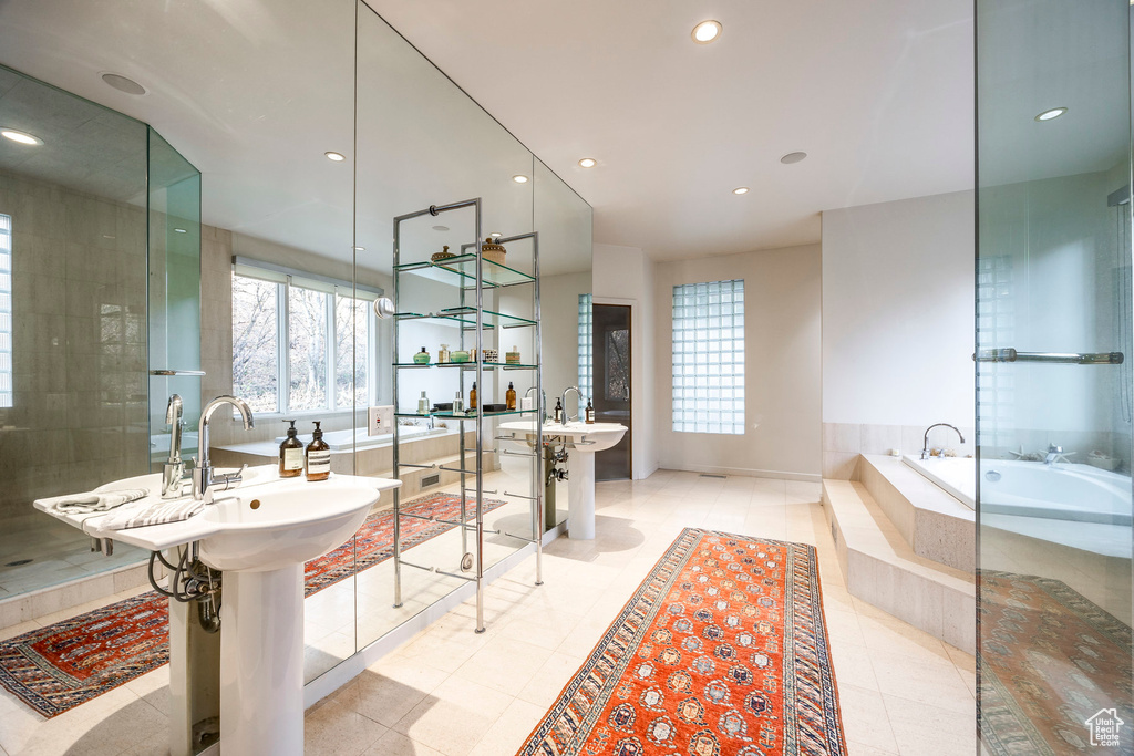 Bathroom with sink, tile patterned floors, and independent shower and bath