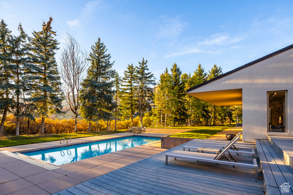 View of pool featuring a wooden deck