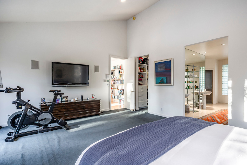 Bedroom with high vaulted ceiling and carpet