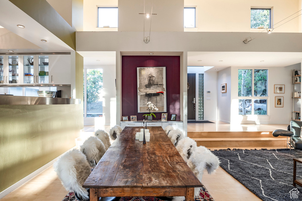 Dining room with a healthy amount of sunlight and a high ceiling