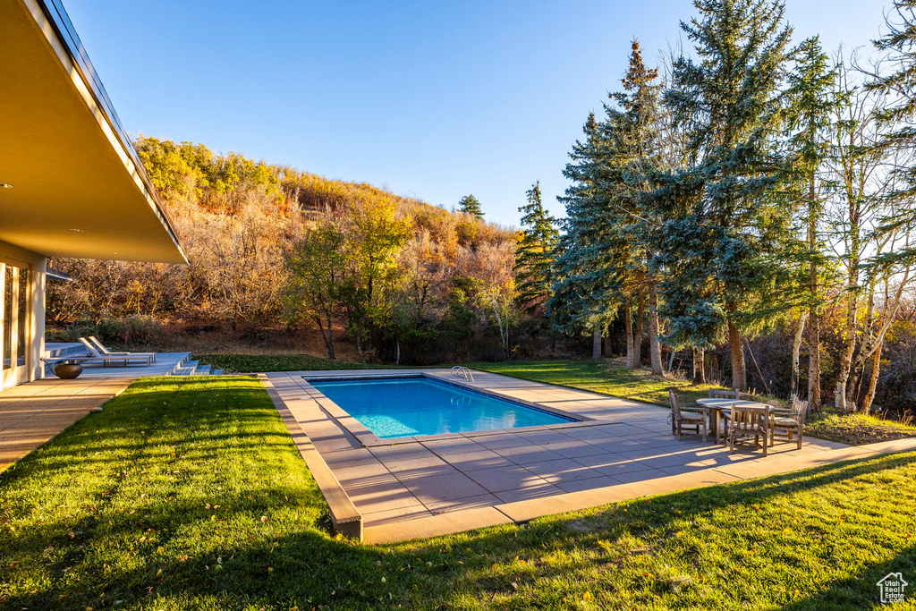 View of swimming pool featuring a yard and a patio area