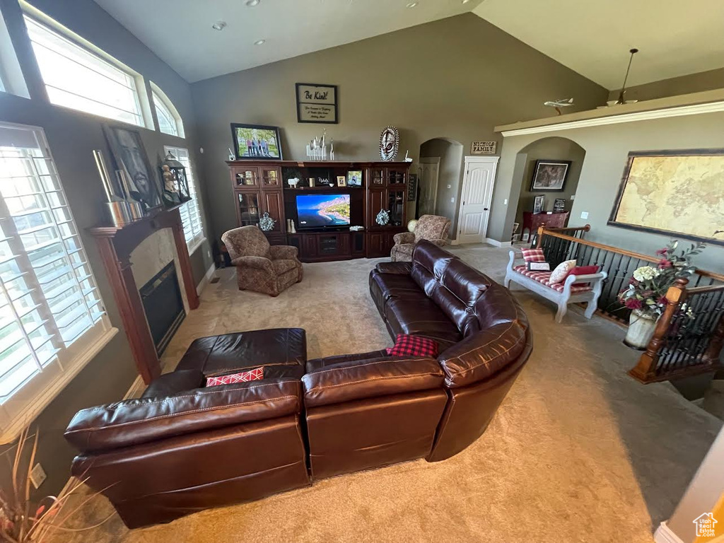 Living room featuring light carpet and high vaulted ceiling