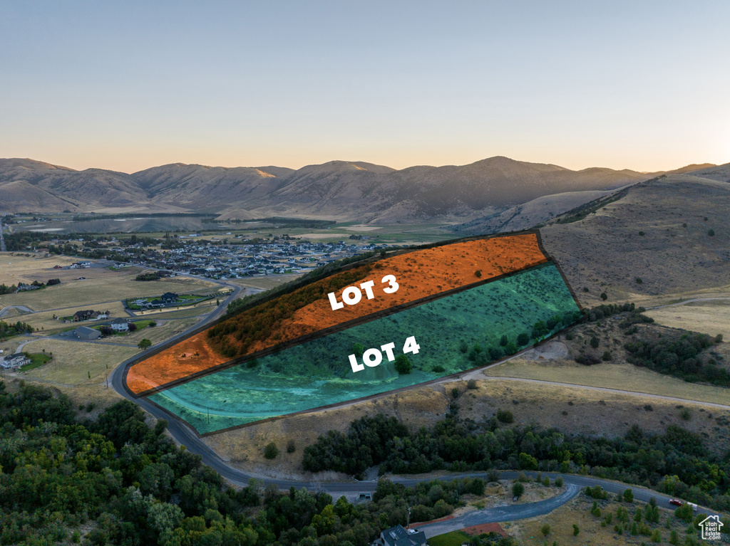 Aerial view at dusk featuring a mountain view