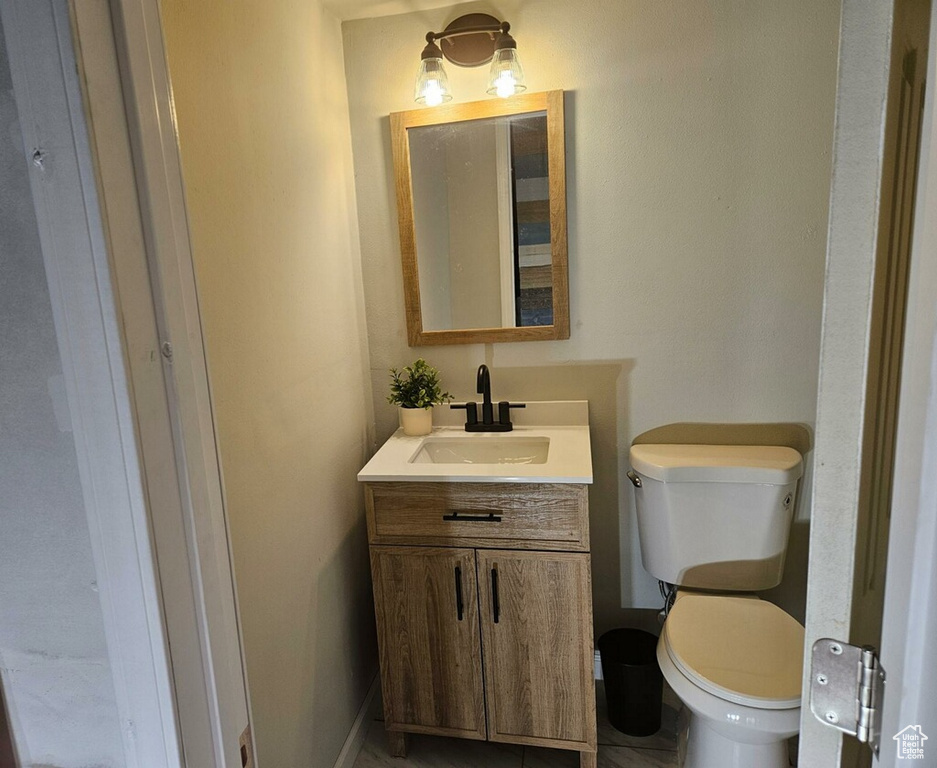 Bathroom with vanity, toilet, and tile patterned floors