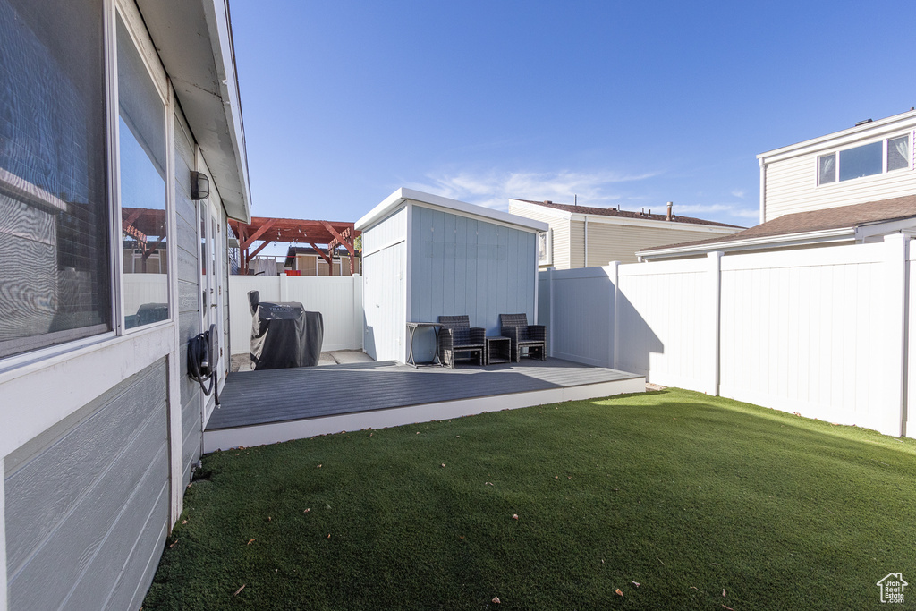 View of yard with a deck and a shed