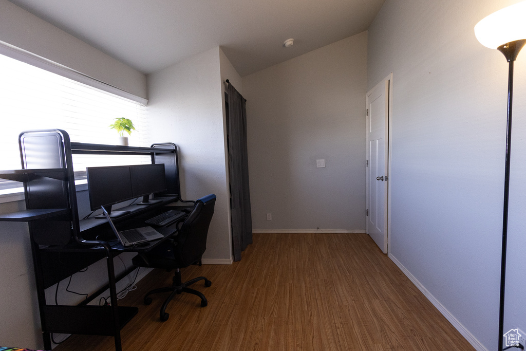 Office featuring lofted ceiling and hardwood / wood-style floors