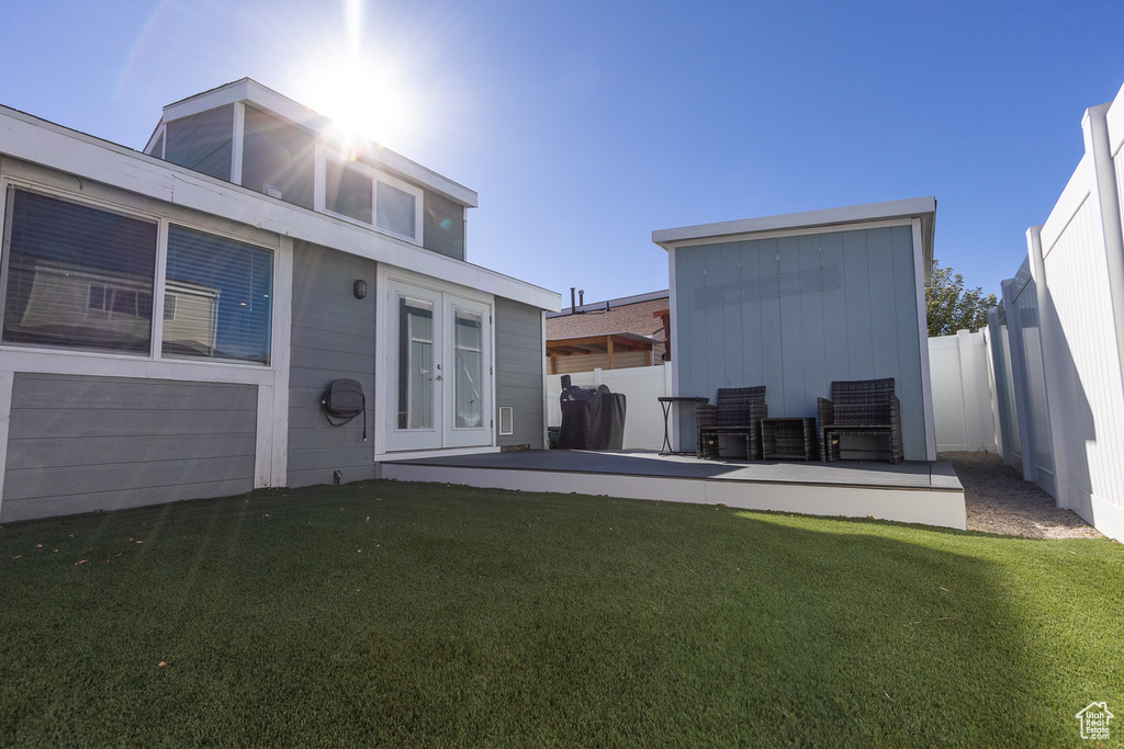 Rear view of house with a yard and a patio area