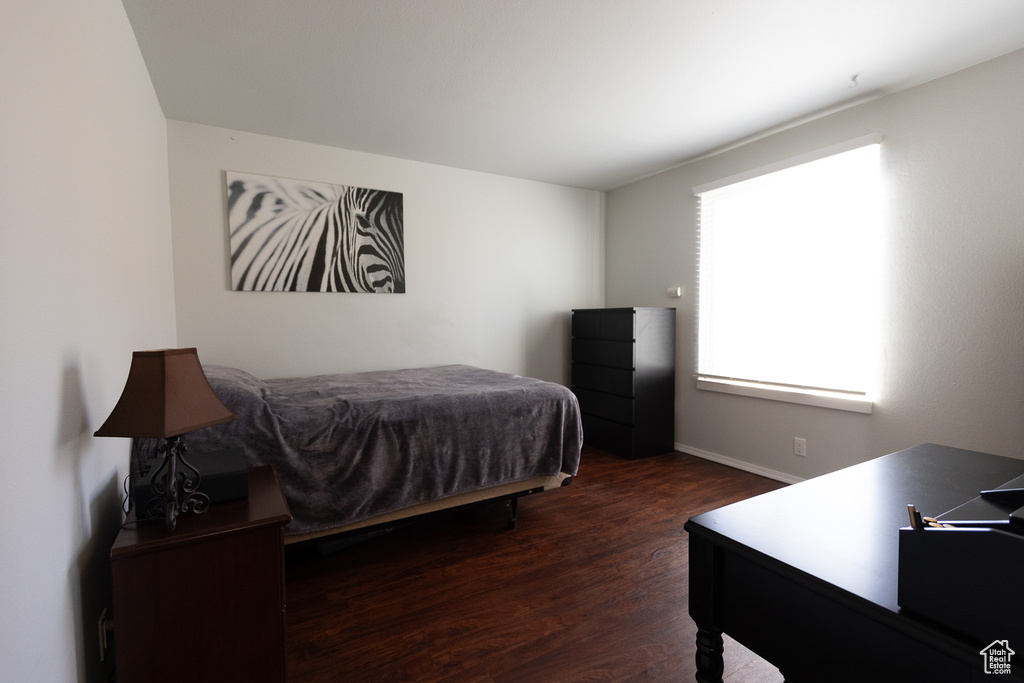 Bedroom with dark wood-type flooring