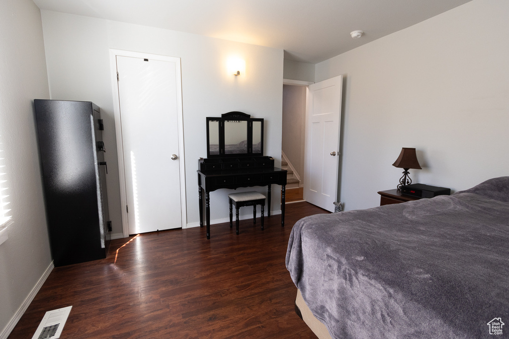 Bedroom with dark hardwood / wood-style floors