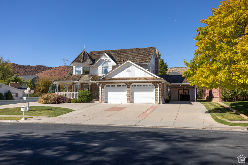 View of front of property featuring a mountain view and a front yard