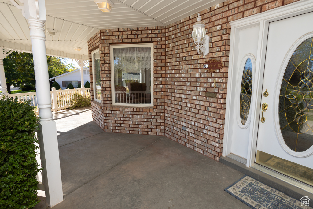 Entrance to property featuring covered porch