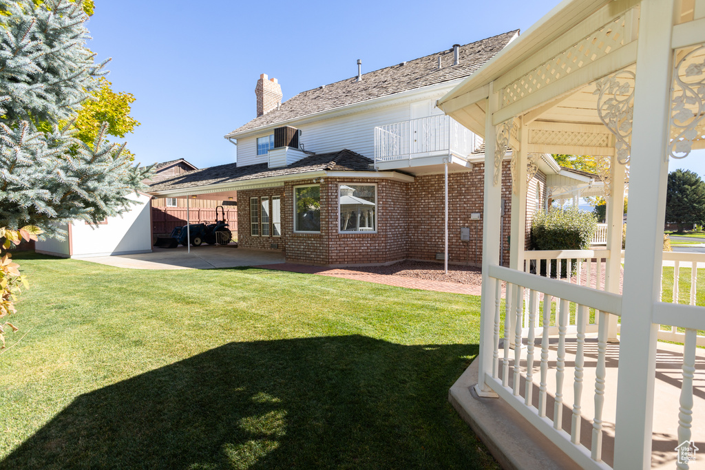 View of yard with a patio and a balcony