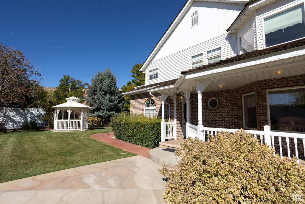 Exterior space featuring a porch and a yard