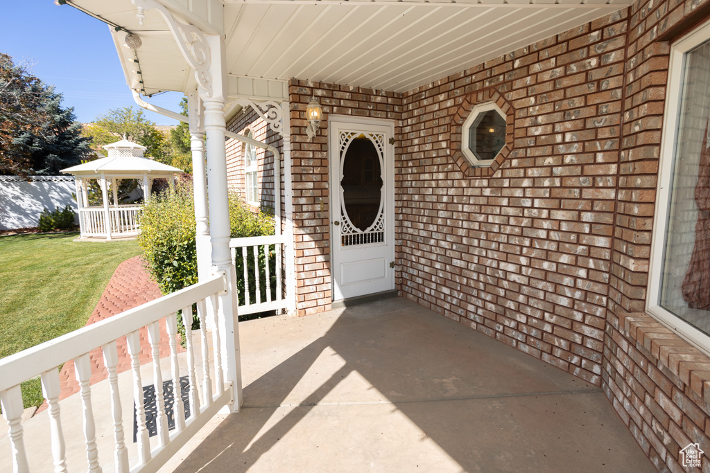 Doorway to property featuring a lawn