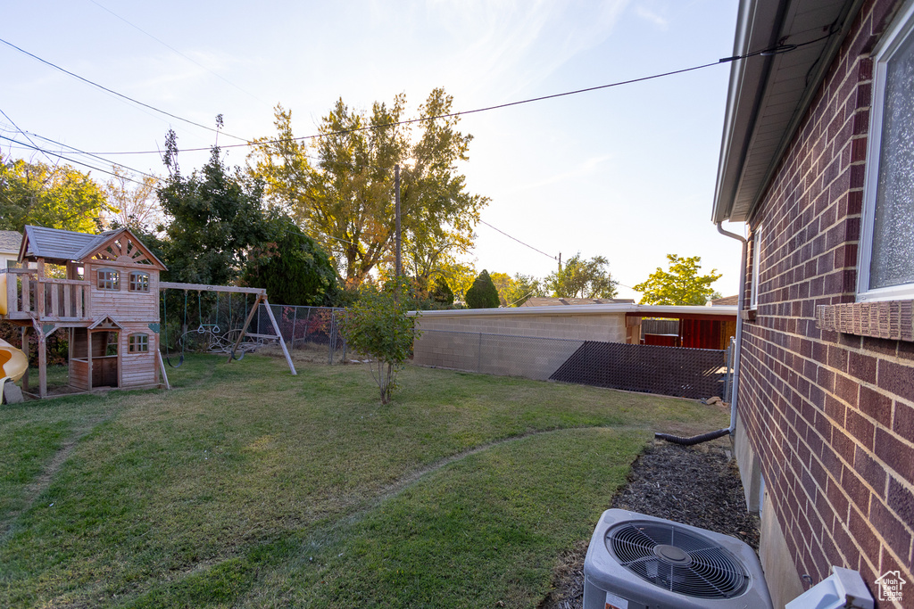 View of yard featuring cooling unit and a playground