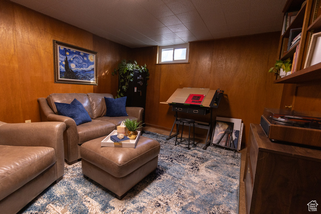 Living room featuring wood walls