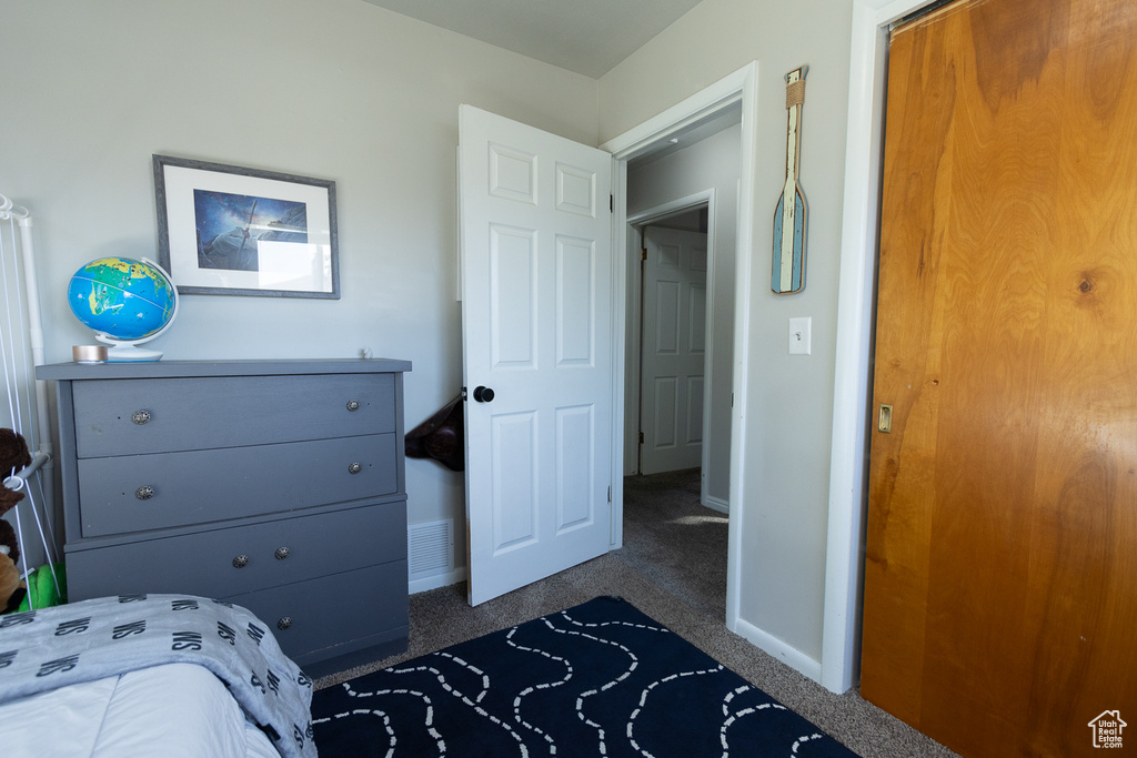 Carpeted bedroom featuring a closet