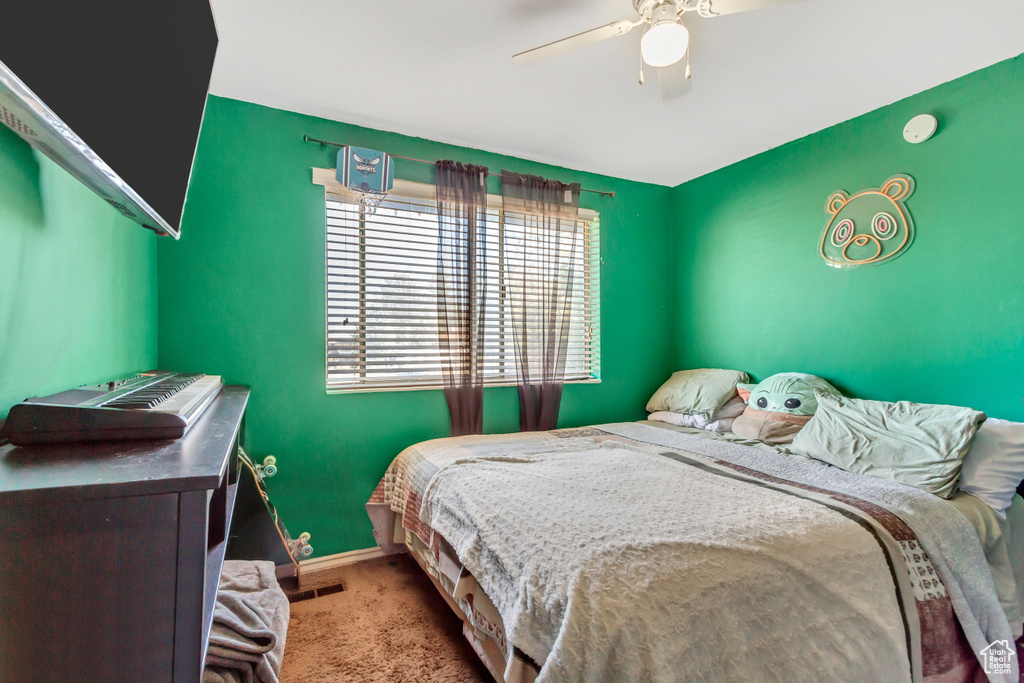 Bedroom featuring ceiling fan and light carpet