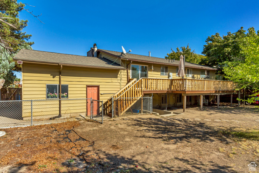 Rear view of house featuring a wooden deck