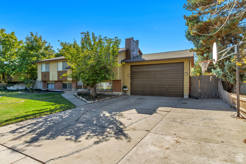 View of front of house featuring a front yard and a garage