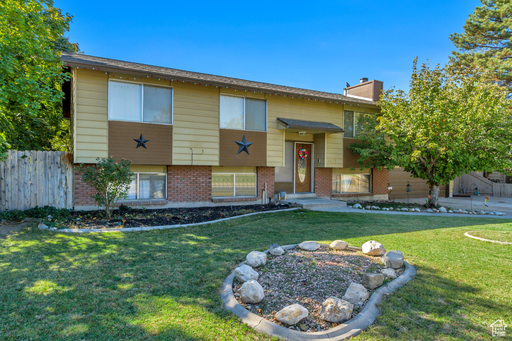 Bi-level home with a front lawn