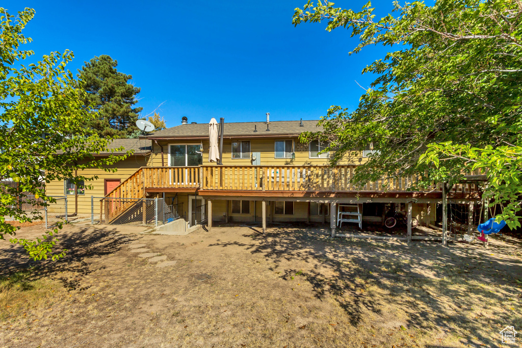 Back of property with a wooden deck