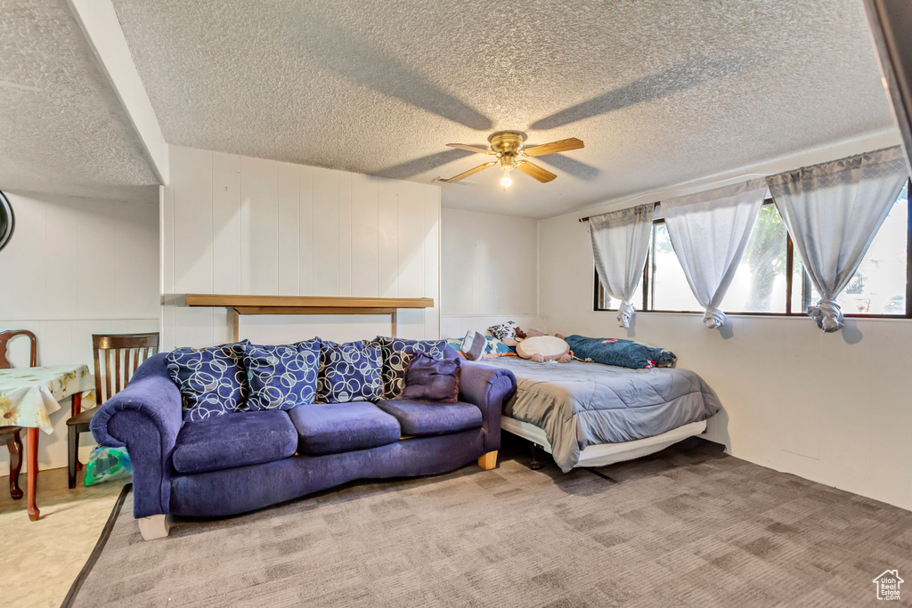 Bedroom with carpet, multiple windows, and ceiling fan