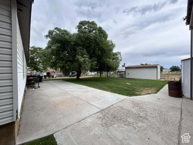 View of patio with a storage shed