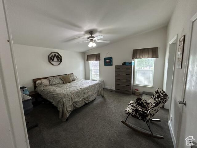 Bedroom featuring lofted ceiling, carpet floors, and ceiling fan