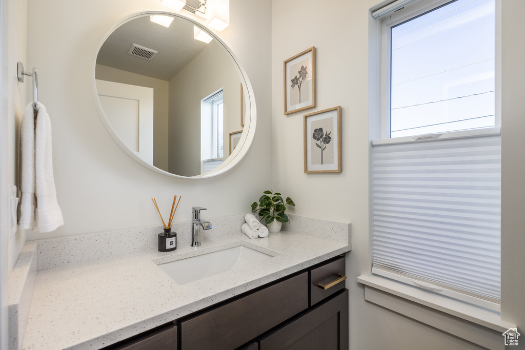 Bathroom with vanity and a healthy amount of sunlight