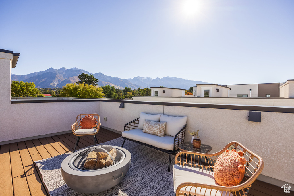 Wooden terrace with a mountain view and a fire pit