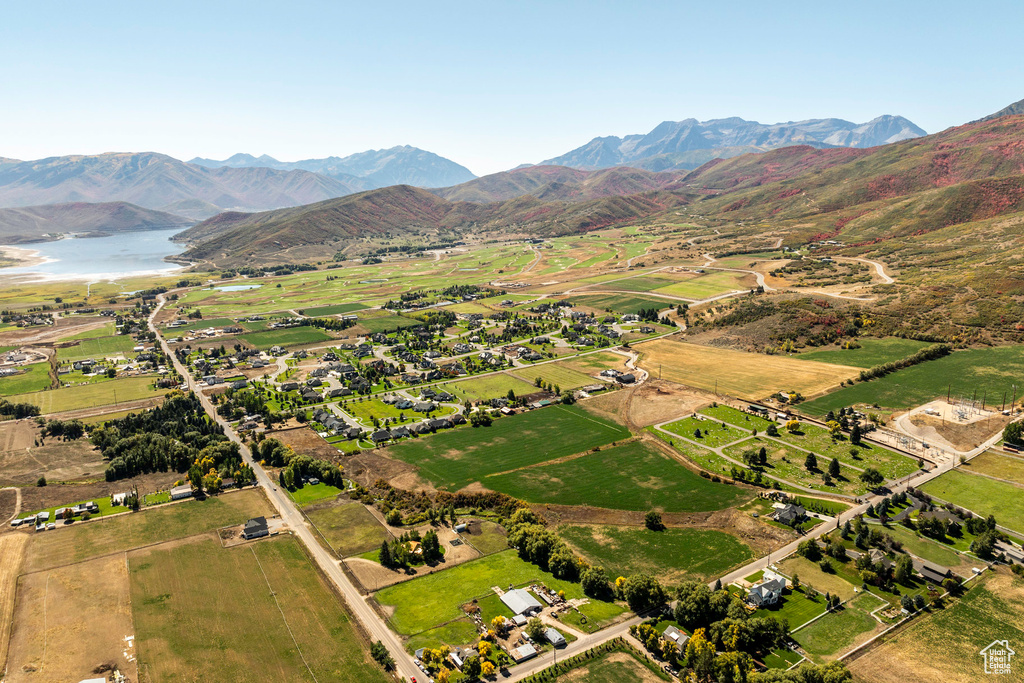 Drone / aerial view featuring a water and mountain view