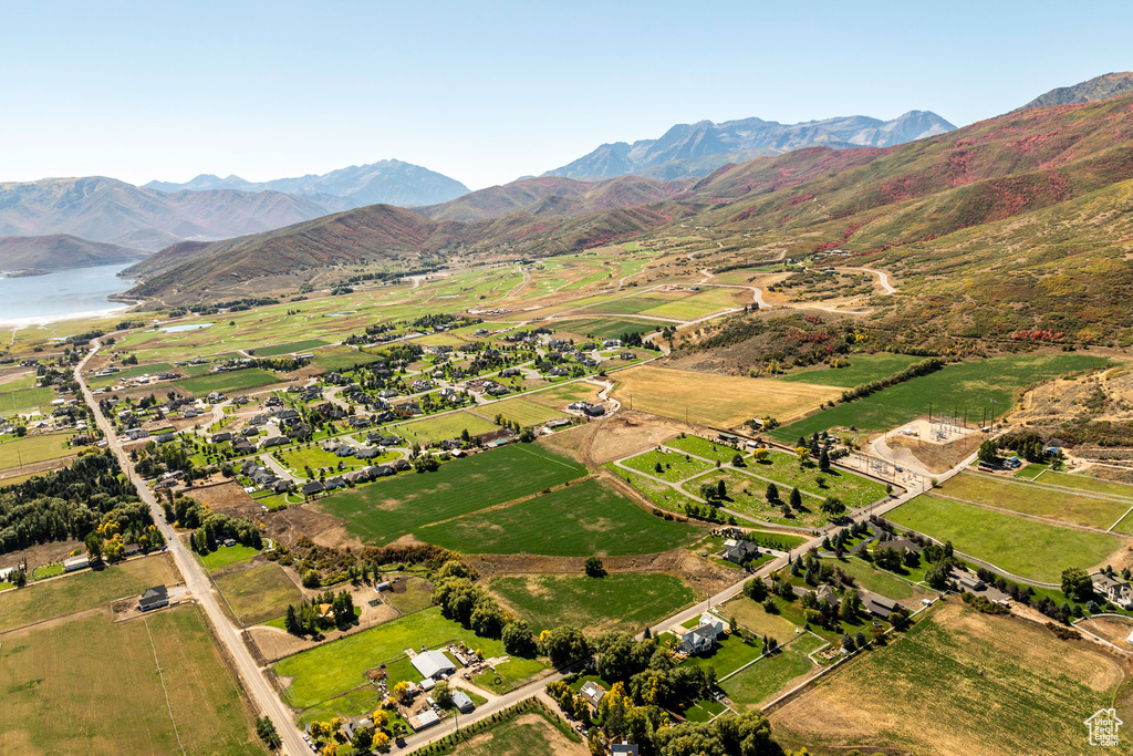 Drone / aerial view featuring a water and mountain view