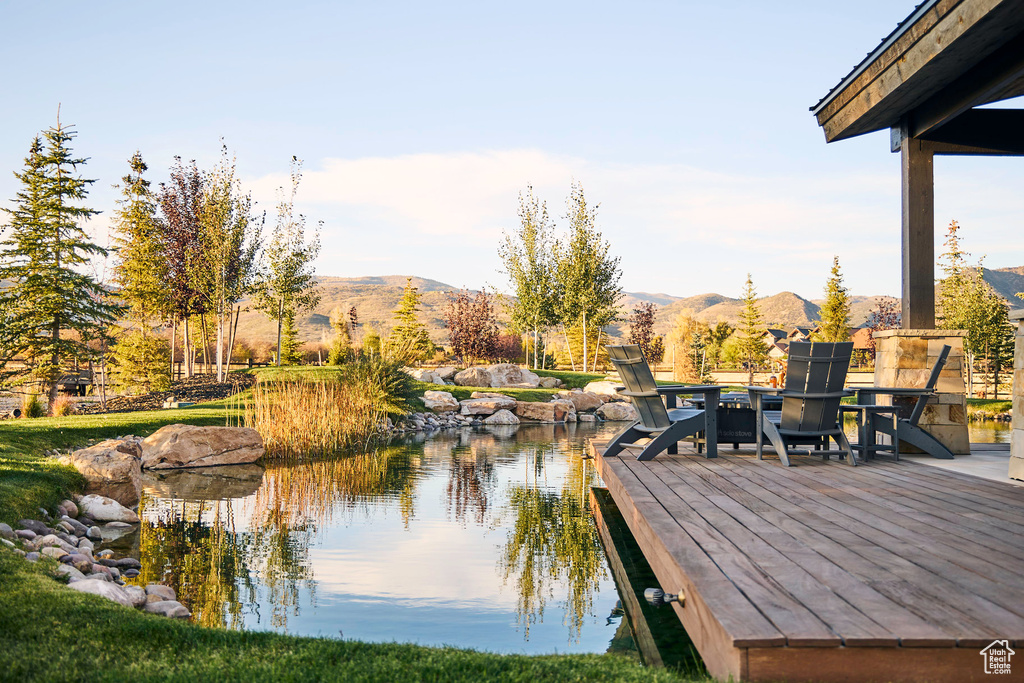 Dock area featuring a water and mountain view