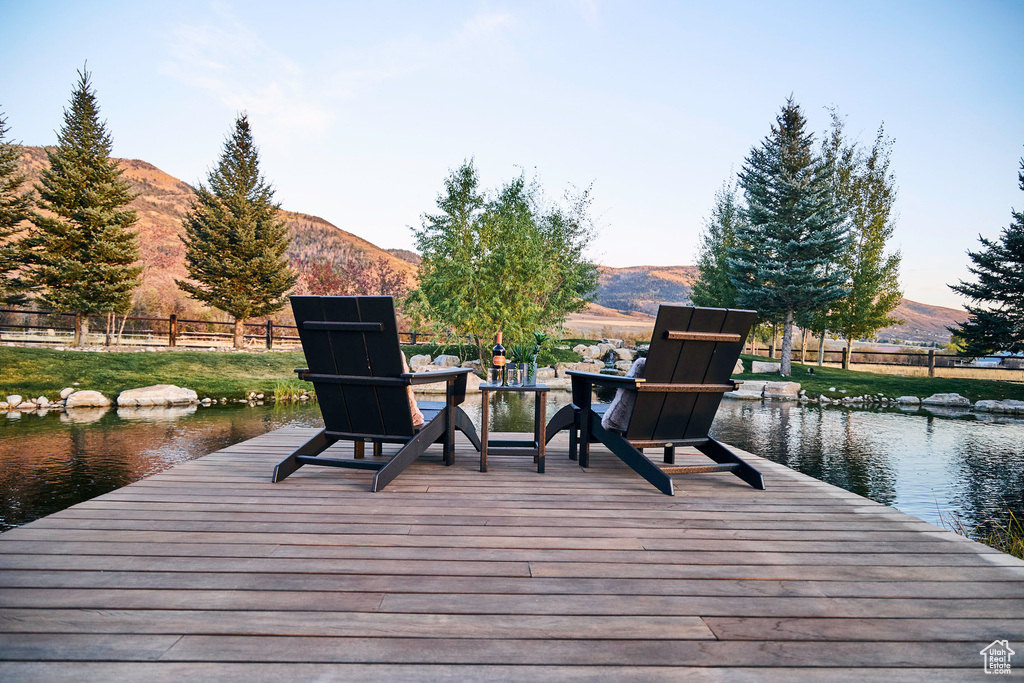 Dock area with a water and mountain view