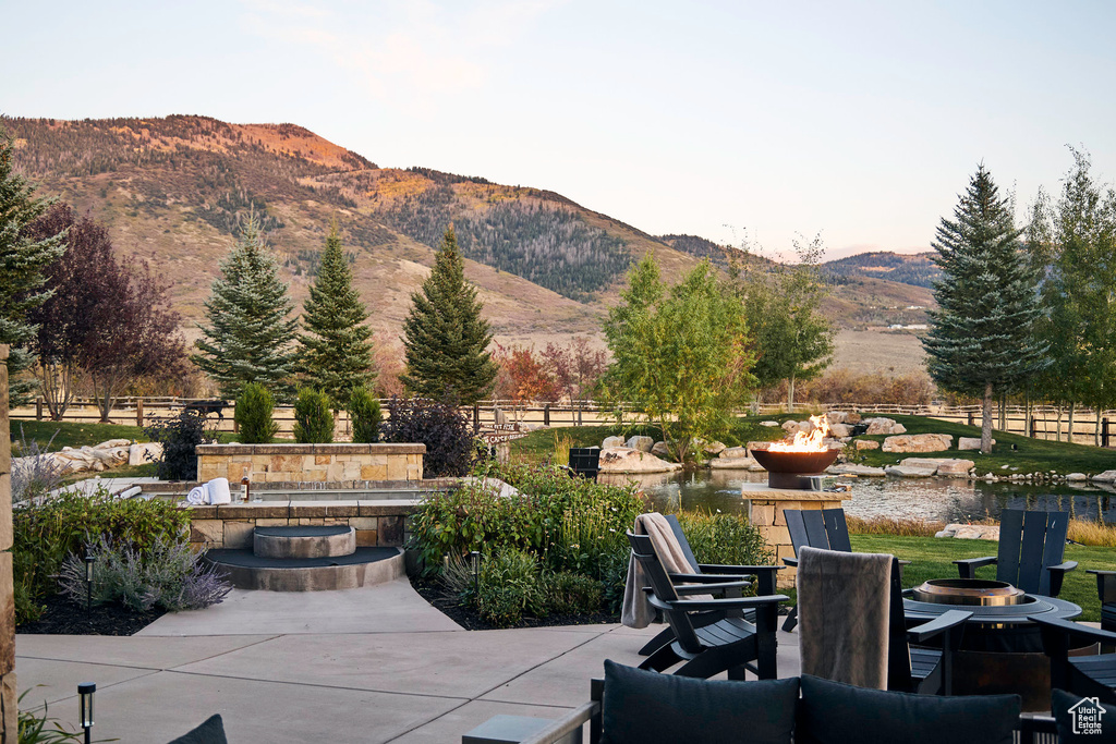 View of patio / terrace featuring a mountain view and a fire pit