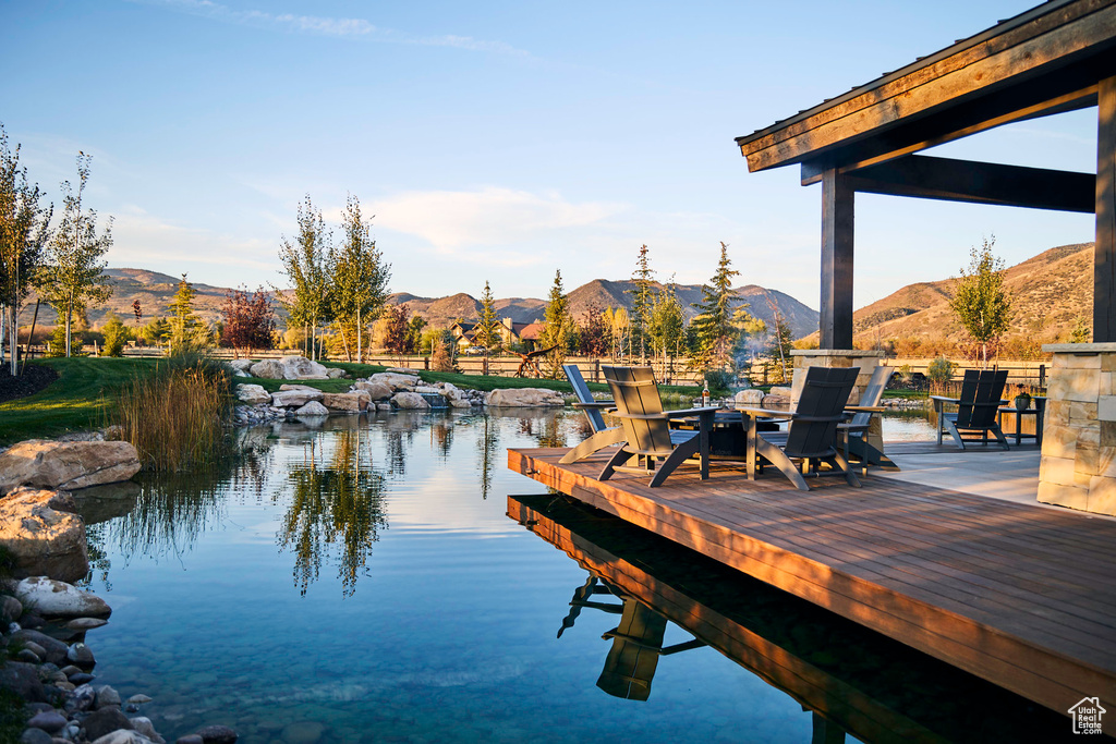 Dock area featuring a water and mountain view