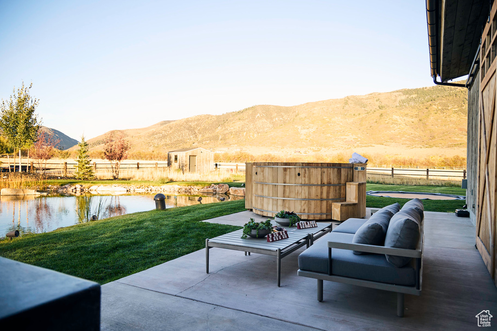 View of patio featuring a water and mountain view